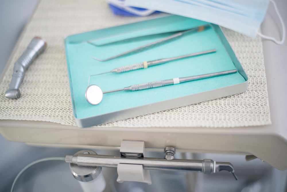 an assortment of dental cleaning tools arranged on a tray