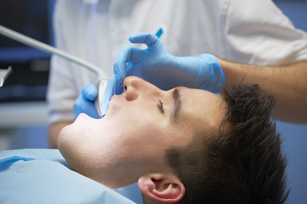 Dentist performing a dental examination for a patient near Fort Garry CC on Pembina in Winnipeg.